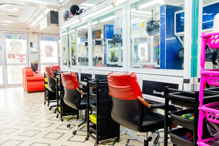 Styling stations near the entrance with red chairs