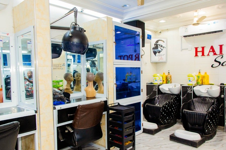 Styling table with mannequin head forms for wig and style prep