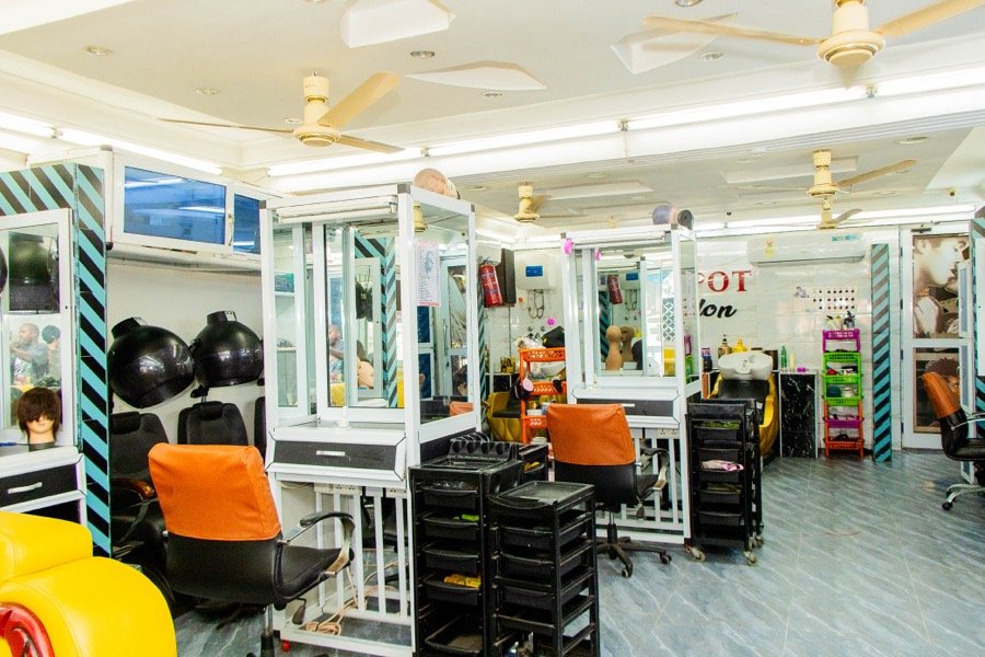 Wide view of the salon floor with gold and yellow furnishings