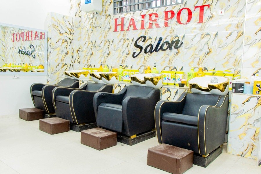 Wash and styling chairs against a marble-patterned feature wall