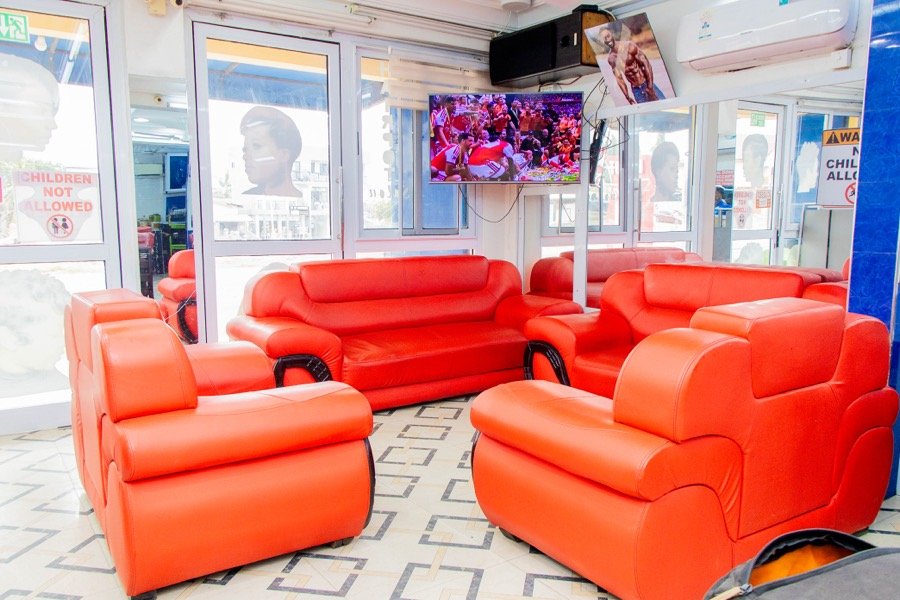 Red leather waiting lounge with a wall-mounted television
