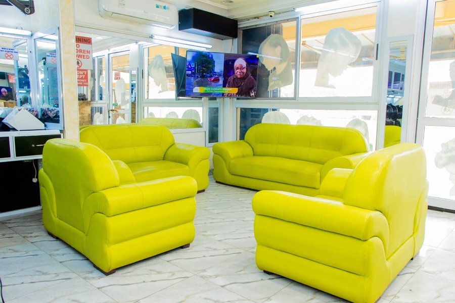 Yellow-green leather waiting lounge with a wall-mounted television