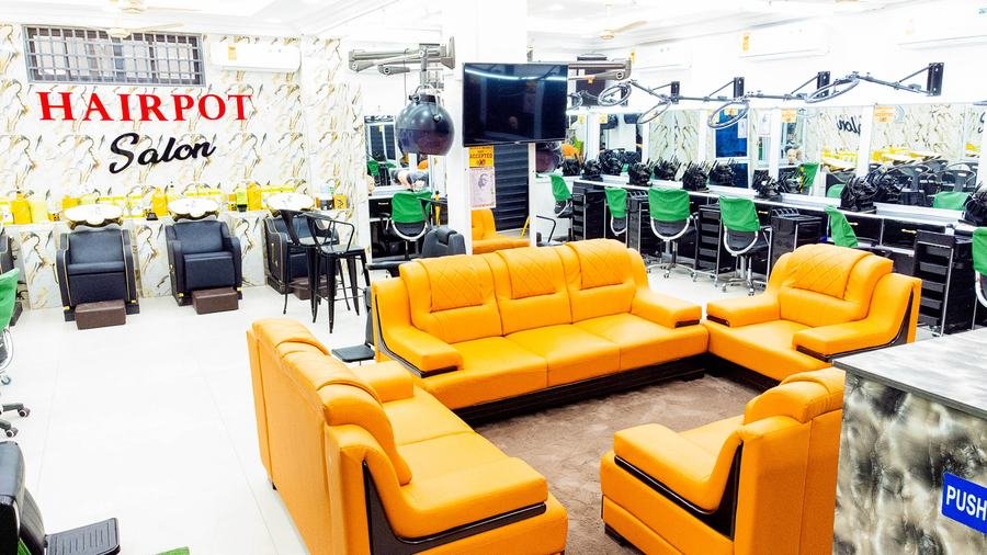 Orange leather waiting lounge with styling stations in the background