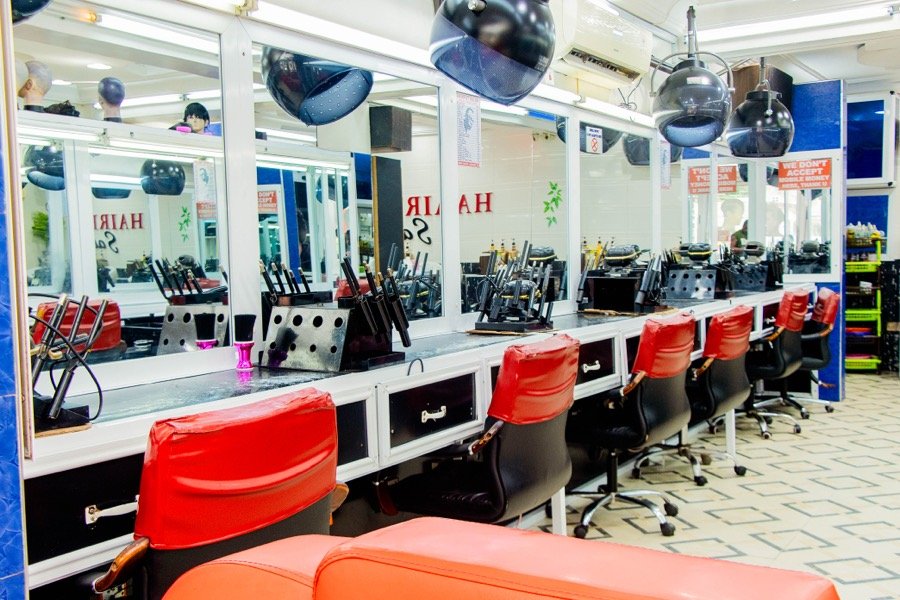 Styling counter with tools laid out and red chairs